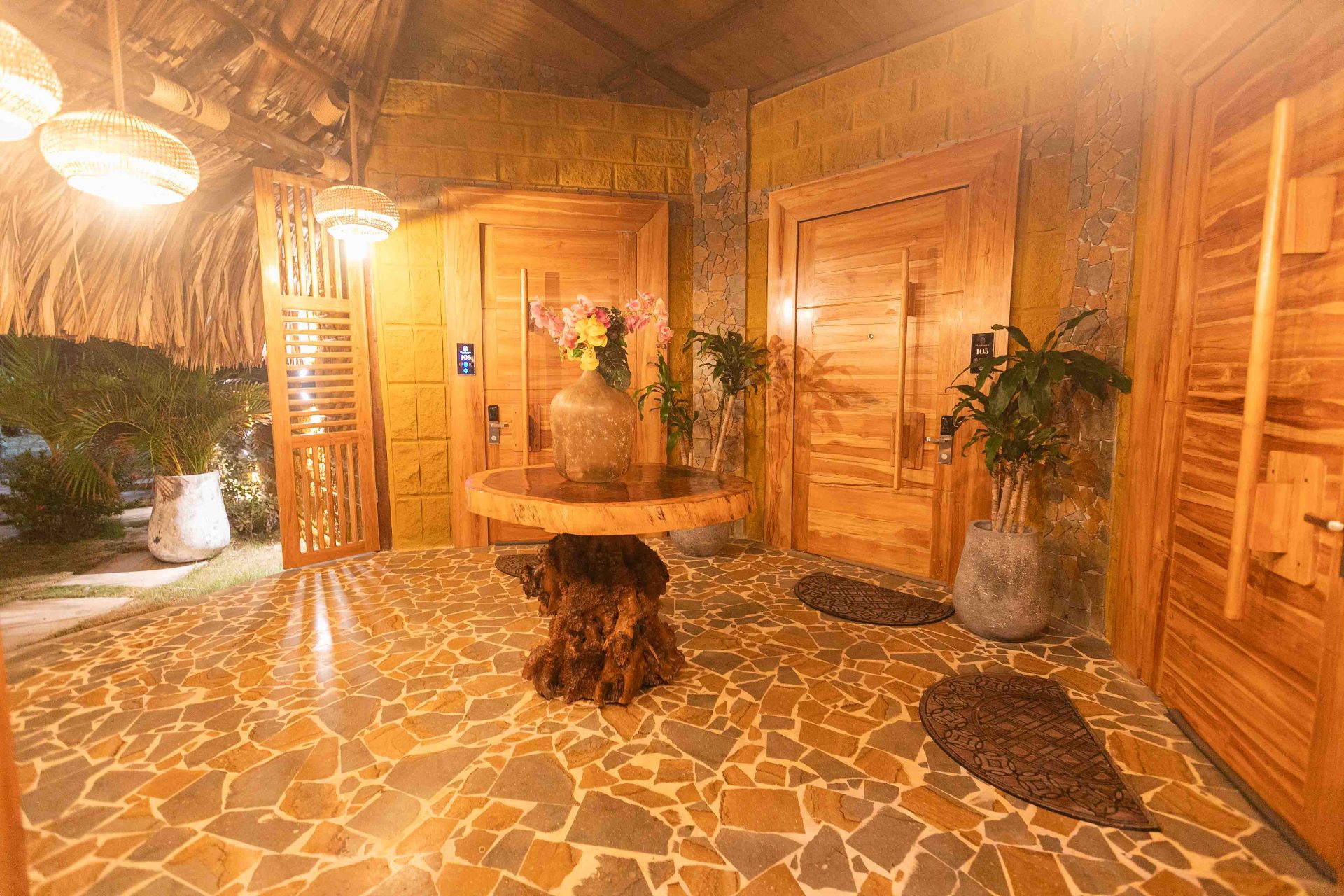 Room corridor with wood and stone architecture at Marahuaco Beach House at night