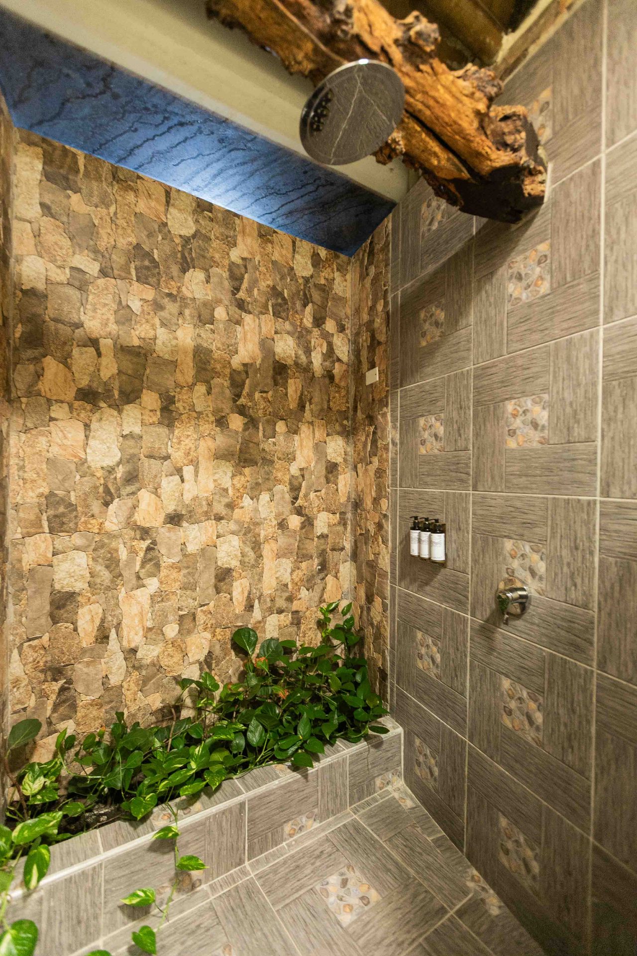 Private bathroom with wood mirror and shower in family villa at Marahuaco Beach House